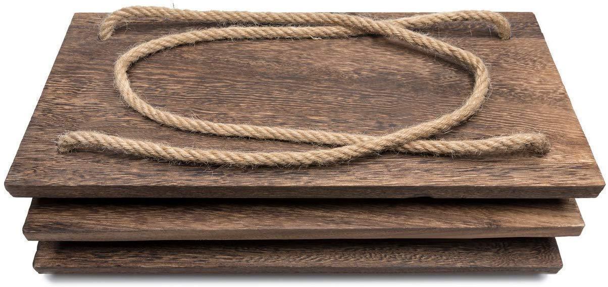 Stack of three rustic dark wooden planks with a thick beige rope on top on white background