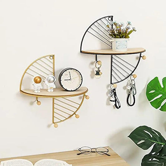Geometric wall-mounted shelves with metal frames, holding astronaut figurines, clock, plant, and keys