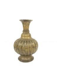 Antique brass vase with ribbed body and engraved neck on white background